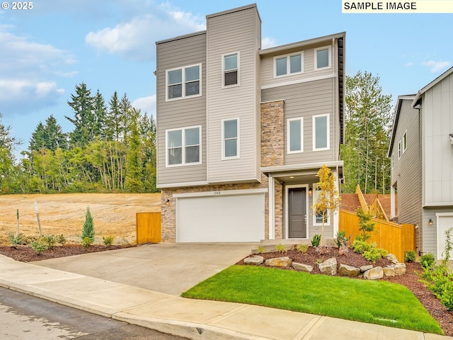 view of front of property with a garage, stone siding, fence, and concrete driveway