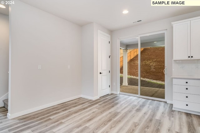 unfurnished room with light wood-type flooring