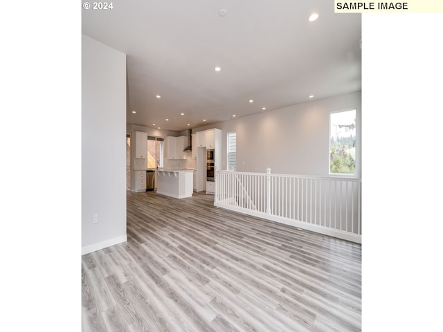 unfurnished living room featuring light hardwood / wood-style flooring