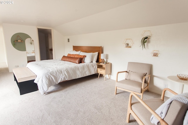 bedroom featuring carpet and vaulted ceiling