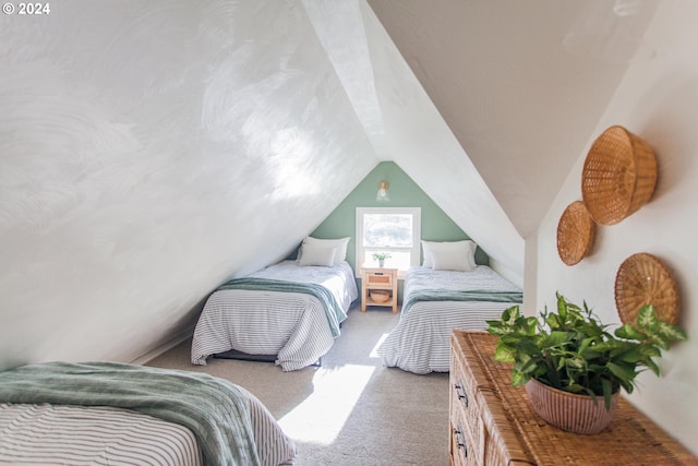 bedroom with carpet and lofted ceiling