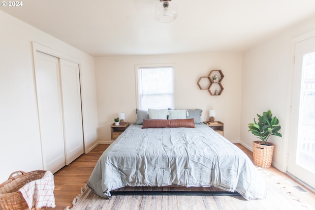 bedroom with baseboards and wood finished floors