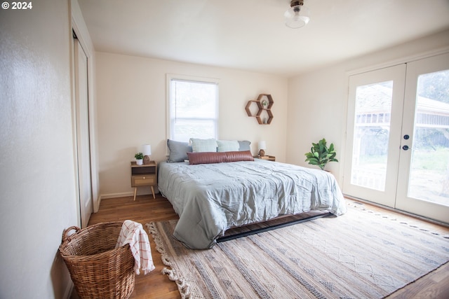 bedroom featuring french doors, wood finished floors, and access to exterior