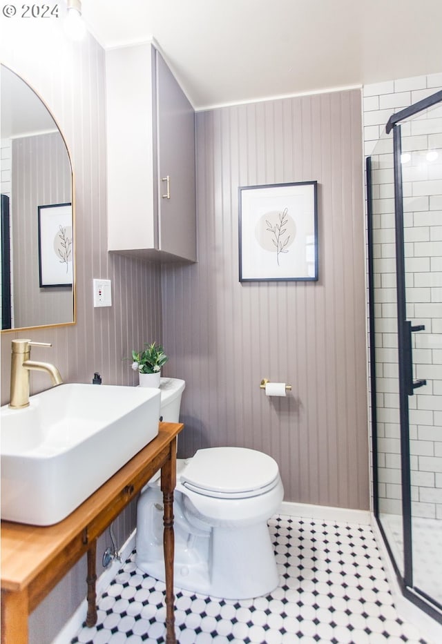 full bath featuring toilet, a shower stall, and a sink