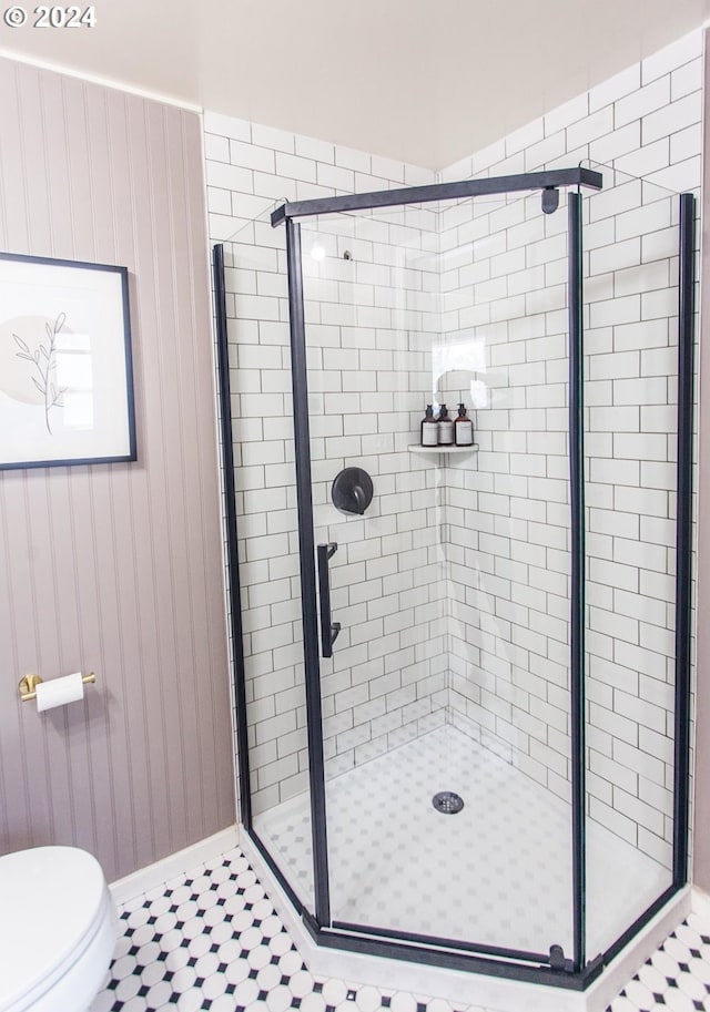 bathroom featuring a stall shower and toilet