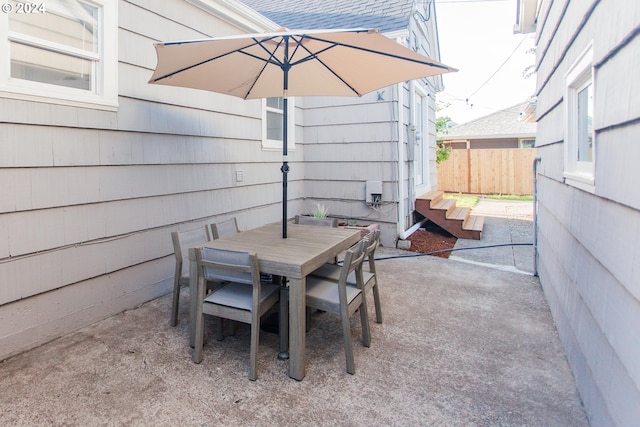 view of patio with fence and outdoor dining area