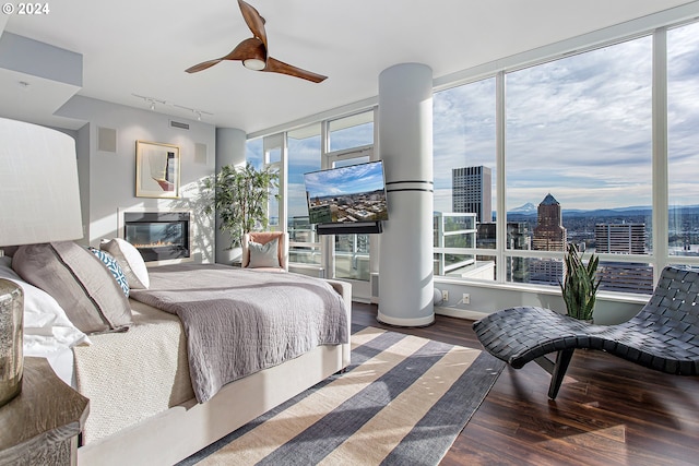 bedroom featuring ceiling fan, track lighting, and hardwood / wood-style flooring