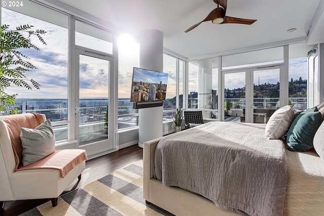 bedroom featuring multiple windows, ceiling fan, and wood-type flooring