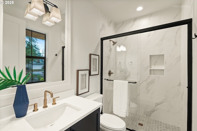 bathroom with vanity, an enclosed shower, and toilet