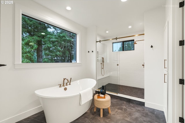 bathroom featuring independent shower and bath