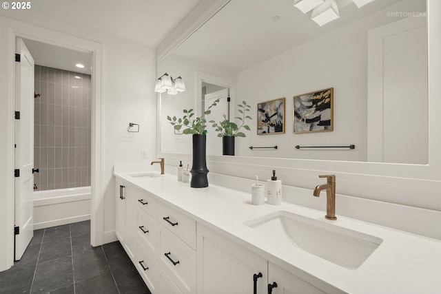 bathroom featuring vanity and tiled shower / bath