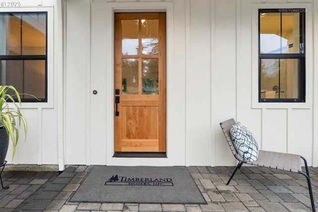 view of exterior entry featuring covered porch