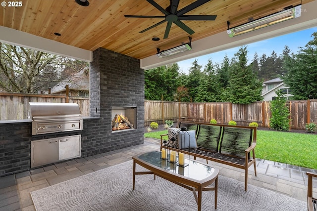 view of patio with an outdoor brick fireplace, area for grilling, and ceiling fan