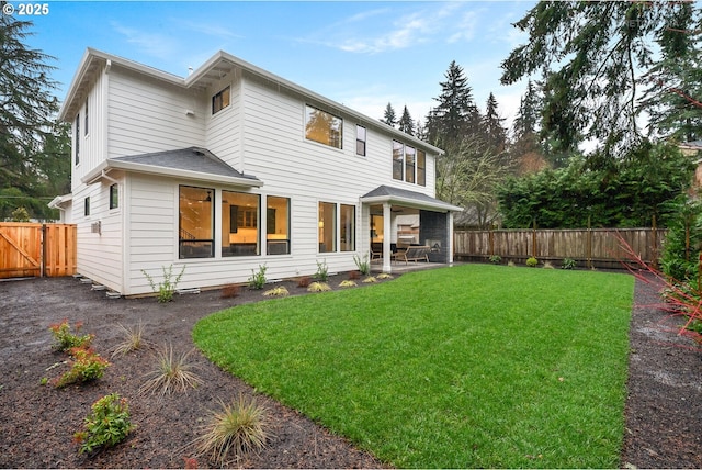 back of property featuring a patio area and a yard