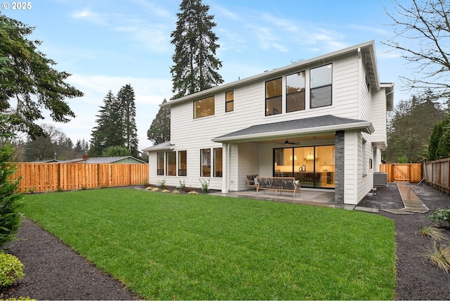 back of property featuring a lawn, ceiling fan, cooling unit, and a patio area