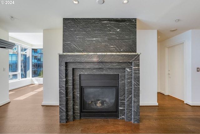 details with a tiled fireplace, recessed lighting, wood finished floors, and baseboards