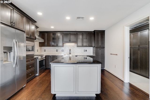 kitchen featuring appliances with stainless steel finishes, dark hardwood / wood-style floors, sink, and dark brown cabinets