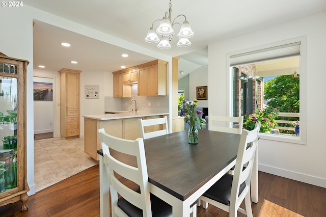 dining space with recessed lighting, baseboards, a chandelier, and wood finished floors