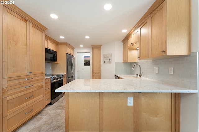 kitchen with appliances with stainless steel finishes, light stone counters, a sink, a peninsula, and decorative backsplash