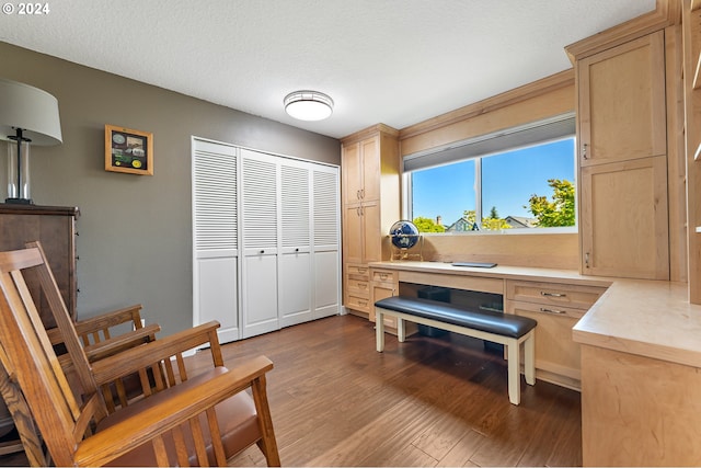 living area featuring a textured ceiling and wood finished floors