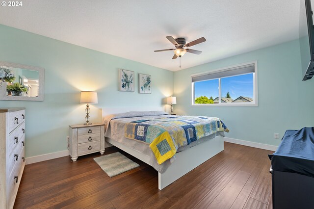 16389 SW 130th Ter # 93, Portland, OR 97224 - bedroom featuring baseboards, a ceiling fan, and dark wood-style flooring