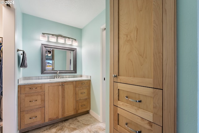 bathroom featuring baseboards and vanity