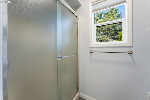 bathroom featuring baseboards and a stall shower