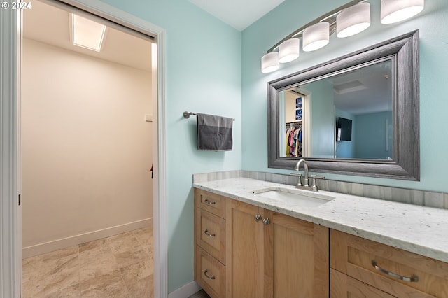bathroom with baseboards and vanity