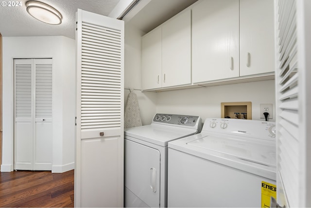 clothes washing area with dark wood-type flooring, cabinet space, and independent washer and dryer