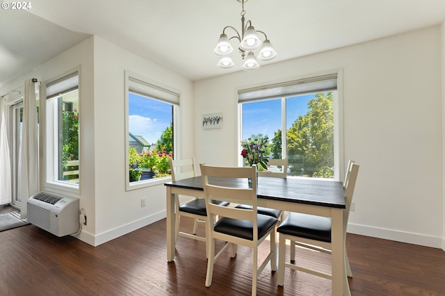 dining space featuring baseboards, a notable chandelier, and dark wood-style floors