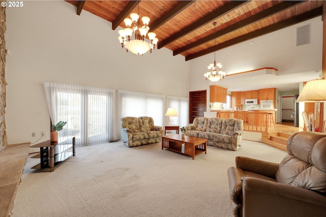 living area featuring a chandelier, beam ceiling, wooden ceiling, and visible vents