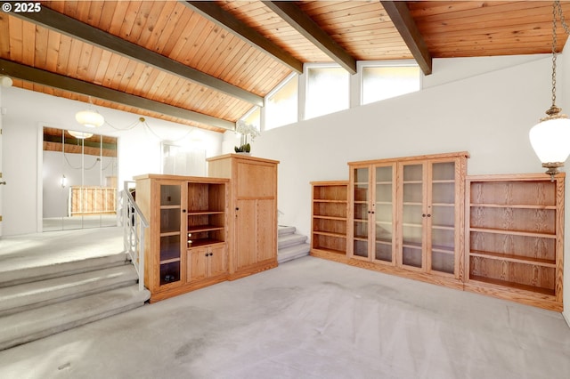 interior space with wood ceiling, stairs, beam ceiling, and light colored carpet