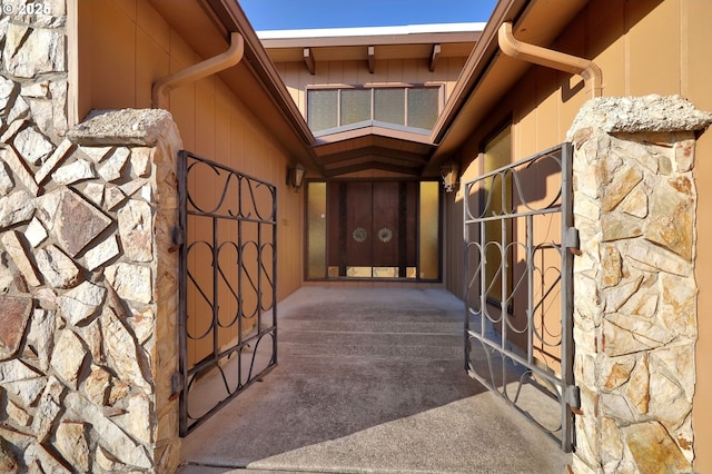 view of exterior entry featuring stone siding