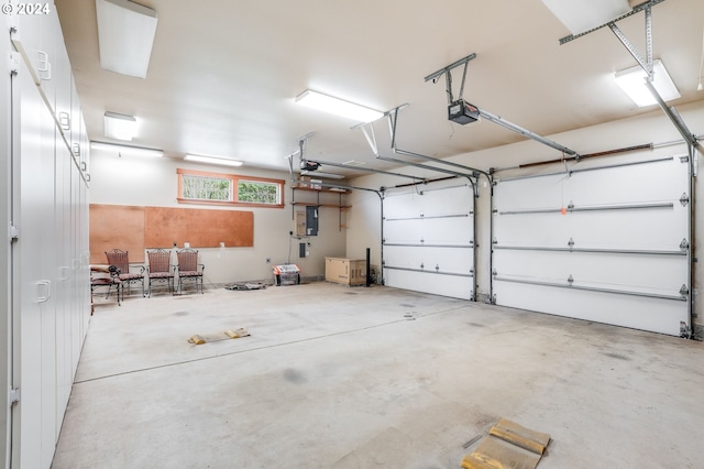 garage with a garage door opener and electric panel