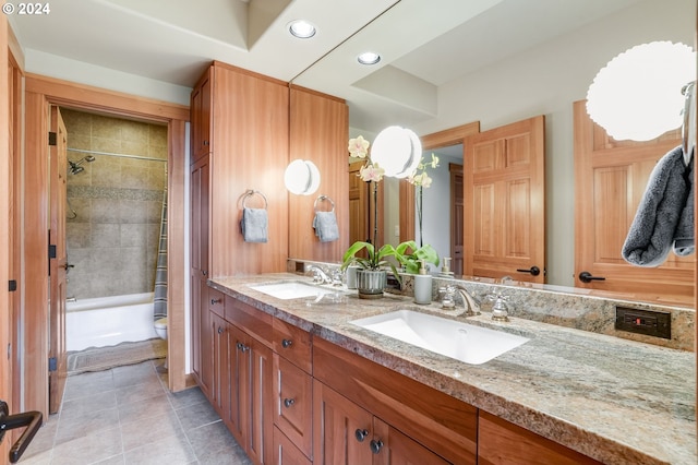 full bathroom featuring tiled shower / bath combo, vanity, toilet, and tile patterned floors