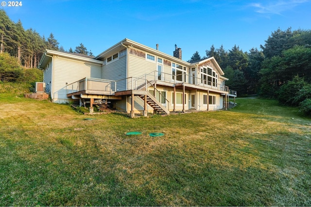 back of house featuring a yard and a wooden deck