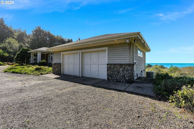 view of side of home featuring a garage and central air condition unit