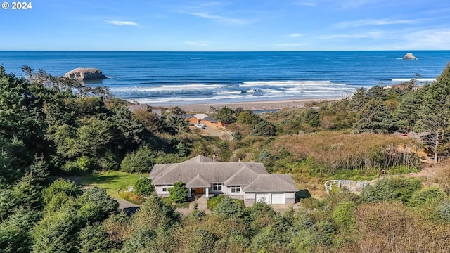 birds eye view of property with a water view and a beach view