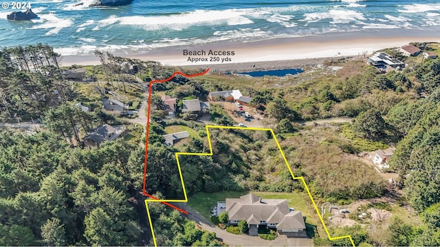 birds eye view of property with a view of the beach and a water view