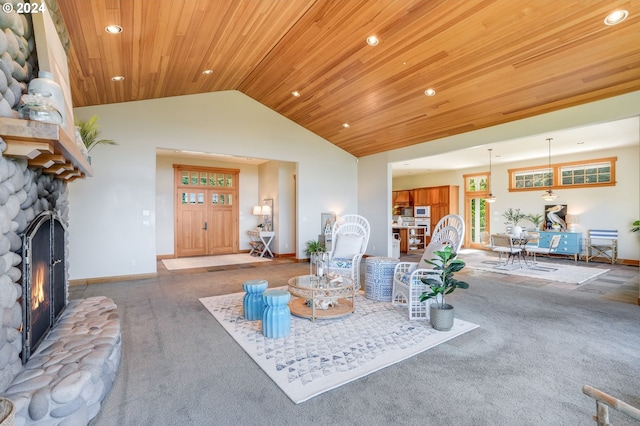 carpeted living room featuring a fireplace, vaulted ceiling, and wood ceiling