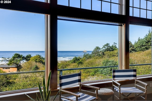 sunroom / solarium with a water view and a healthy amount of sunlight