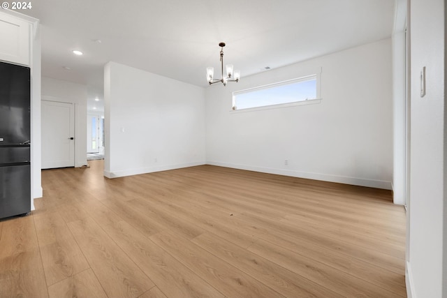 interior space with light wood-type flooring and a notable chandelier