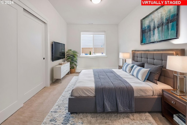 bedroom featuring light carpet