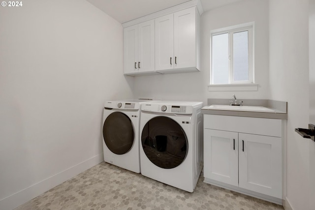 laundry area with separate washer and dryer, sink, and cabinets