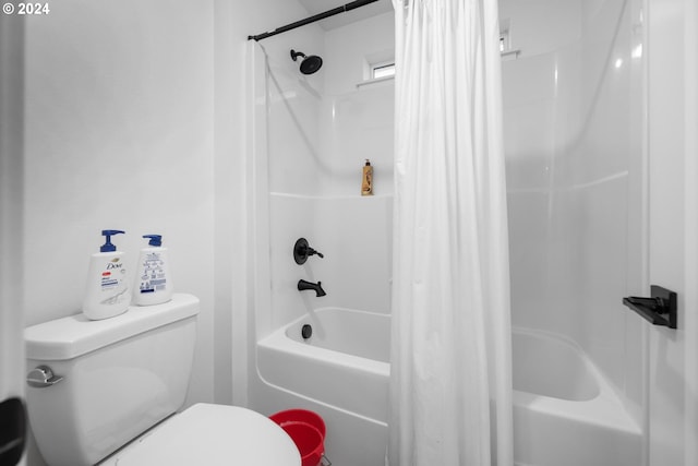 bathroom with shower / tub combo and toilet