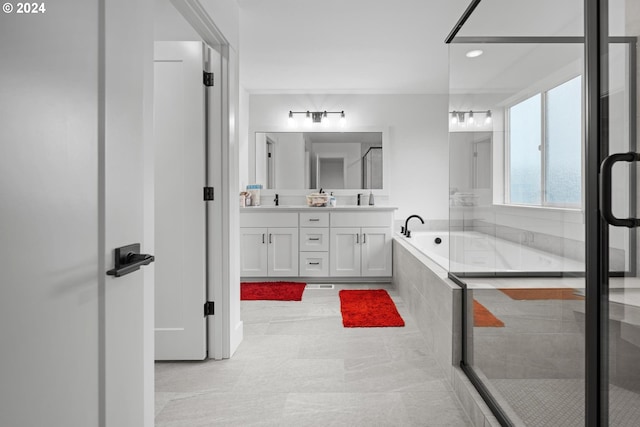 bathroom featuring shower with separate bathtub and vanity