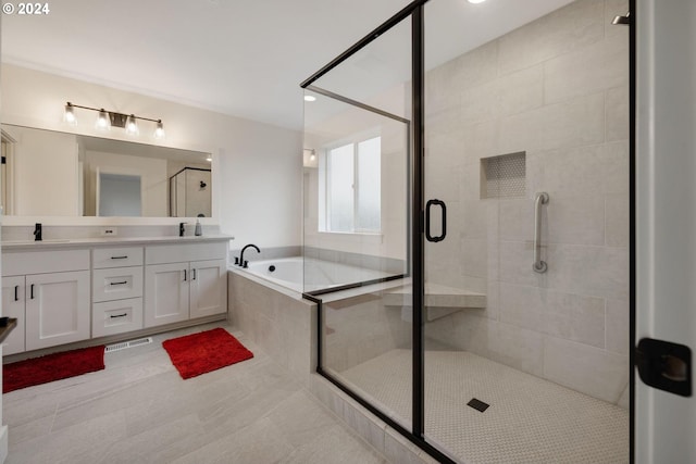 bathroom featuring plus walk in shower, vanity, and tile patterned floors