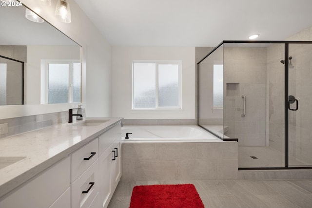 bathroom with plus walk in shower, vanity, and tile patterned floors