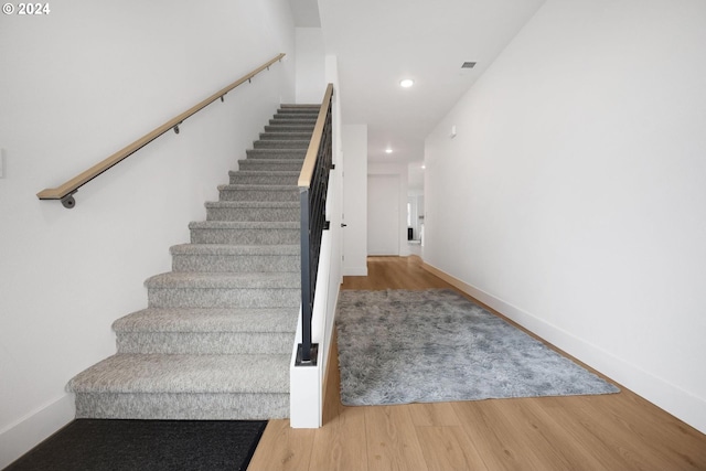 staircase featuring hardwood / wood-style floors