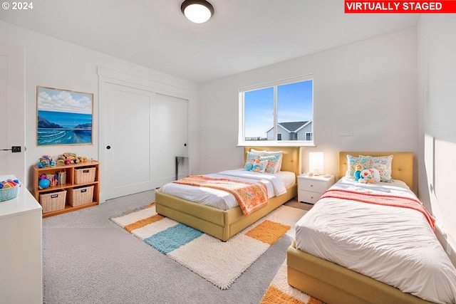 bedroom featuring light carpet and a closet